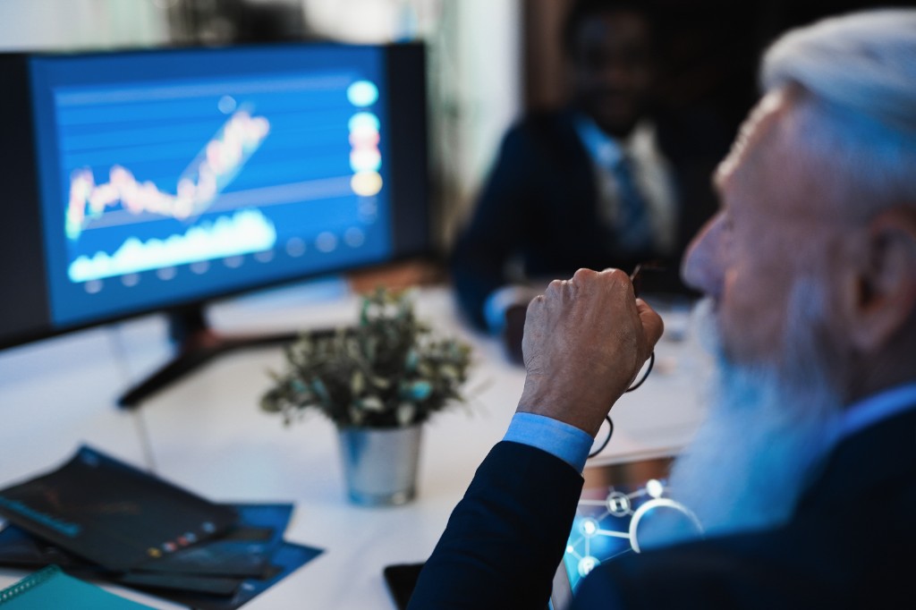 Professional reviewing analytics and commission-style charts in a modern office